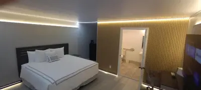 a bedroom with a large white bed in a room at Mountain View Motel in Bishop