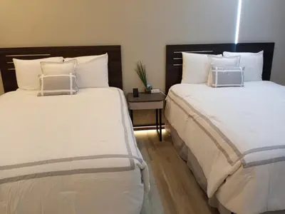 two beds sitting next to each other in a room at Mountain View Motel in Bishop
