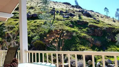 a view from the balcony of a house with a mountain at Sacred Mtn River Suites in Kernville