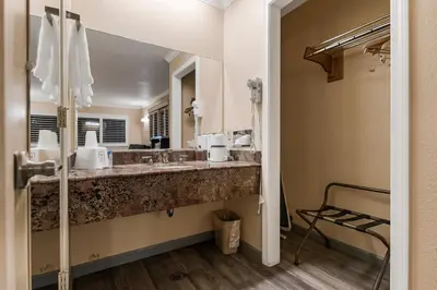 a bathroom with a sink and a large mirror at Country Inn Sonora in Sonora