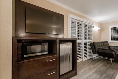a living room with a large entertainment center with a flat screen tv at Country Inn Sonora in Sonora