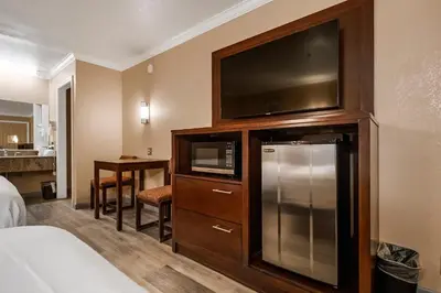 a hotel room with a large entertainment center with a flat screen tv at Country Inn Sonora in Sonora