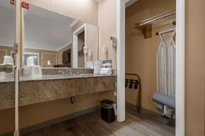 a bathroom with a sink and a large mirror at Country Inn Sonora in Sonora
