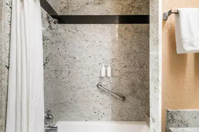 a shower in a hotel bathroom with a tub at Country Inn Sonora in Sonora
