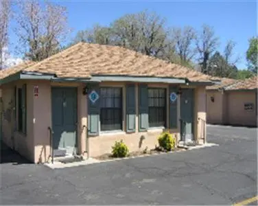 a small house in a parking lot at Bishop Elms Motel in Bishop