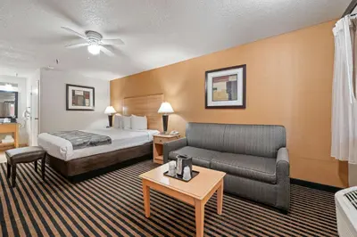 a hotel room with a bed and a couch at Best Western Plus Executive Inn & Suites in Manteca
