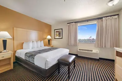 a hotel room with a bed and a large window at Best Western Plus Executive Inn & Suites in Manteca