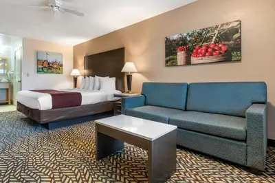 a hotel room with a bed and a couch at Best Western Orchard Inn in Turlock