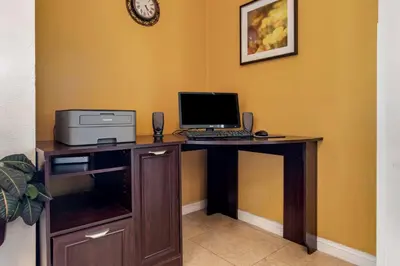 a desk with a computer and a printer on it at Best Western Orchard Inn in Turlock