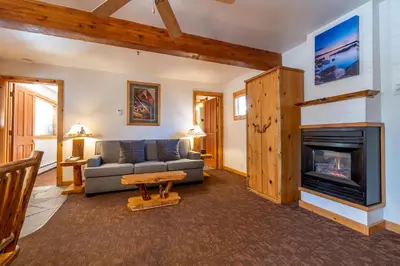 a living room with a couch and a fireplace at Red Wolf Lakeside Lodge in Tahoe Vista
