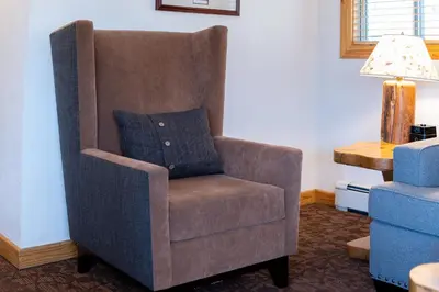 a brown chair with a blue pillow in a room at Red Wolf Lakeside Lodge in Tahoe Vista