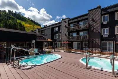a resort with two hot tubs on a deck at Red Wolf Lodge at Olympic Valley in Olympic Valley