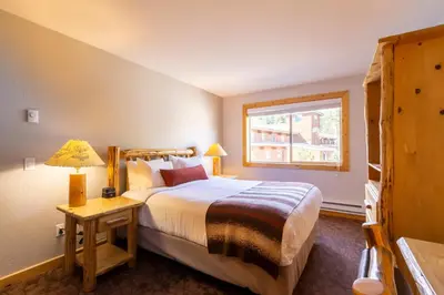 a bedroom with a large bed and a window at Red Wolf Lodge at Olympic Valley in Olympic Valley