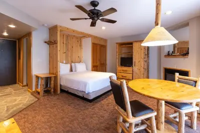 a bedroom with a bed and a dining room table at Red Wolf Lodge at Olympic Valley in Olympic Valley