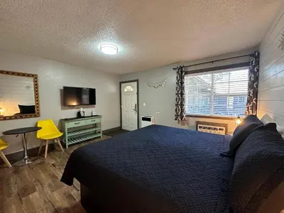 a bedroom with a bed and a desk and a television at Lake Ridge South Lake Tahoe in South Lake Tahoe