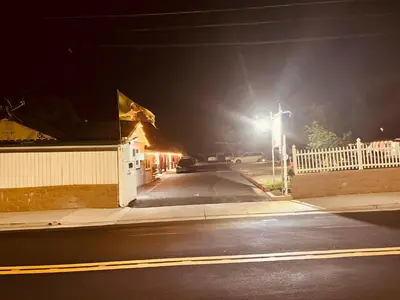 an empty street at night with a street light at Jumping Frog Motel in Angels Camp