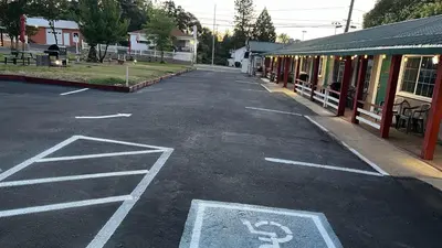 an empty street in a town with a bike lane at Jumping Frog Motel in Angels Camp