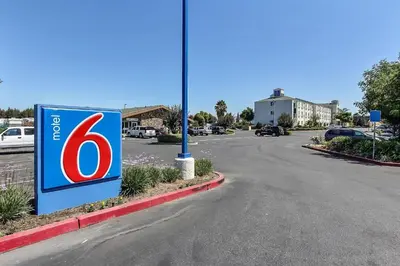 a sign on the side of a road at Motel 6-Gilroy, CA in Gilroy
