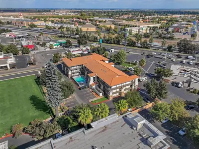 an overhead view of a building with an orange roof at Hillstone Inn Tulare, an Ascend Collection Hotel in Tulare