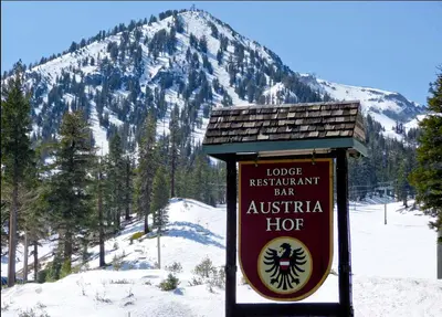a sign in front of a snow covered mountain at Austria Hof Lodge in Mammoth Lakes