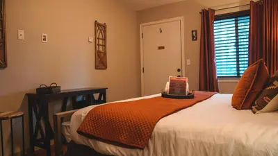 a bedroom with a bed and a table and a window at Playpark Lodge in South Lake Tahoe