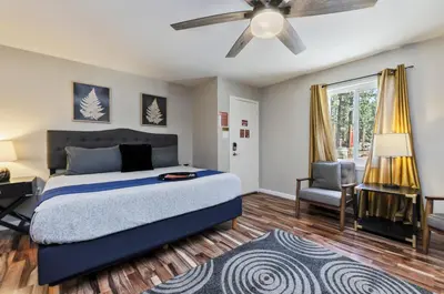 a bedroom with a bed and a ceiling fan at Playpark Lodge in South Lake Tahoe