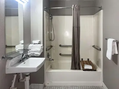 a bathroom with a sink and a tub and a shower at Motel 6-Tulare, CA in Tulare