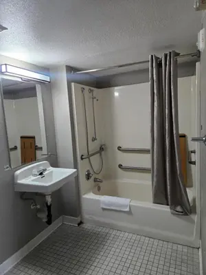a bathroom with a tub and a sink and a shower at Super 8 by Wyndham Tracy in Tracy