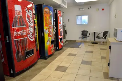 a row of cocacola soda machines in a room at Motel 6 - Santa Nella, on i-5 in Santa Nella Village