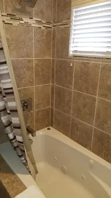 a bath tub in a bathroom with a window at Gondola Lodge & Tahoe Beach Club in South Lake Tahoe