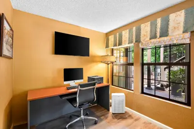 a room with a desk with a computer and a window at Best Western Stagecoach Inn in Pollock Pines