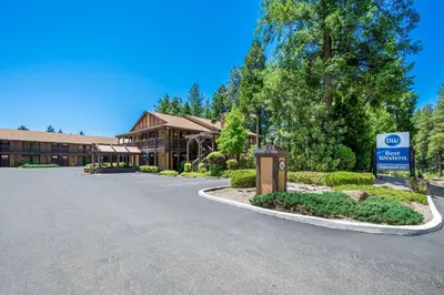 a building with a sign in front of a building at Best Western Stagecoach Inn in Pollock Pines