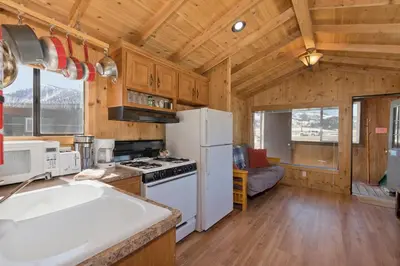 a kitchen with a white refrigerator and a stove at Sierra Meadows Ranch in Mammoth Lakes