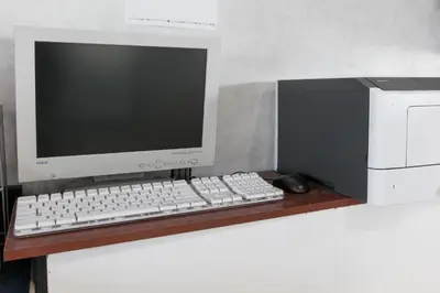 a computer monitor and a keyboard and mouse on a desk at Super 8 by Wyndham Bishop in Bishop