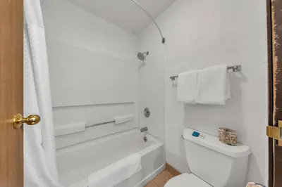 a white bathroom with a tub and a toilet at Days Inn by Wyndham Carson City in Carson City