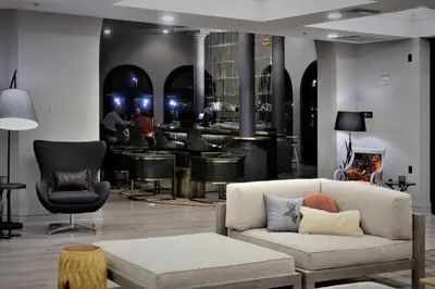 a living room with a couch and a bar at Renaissance Reno Downtown Hotel & Spa in Reno