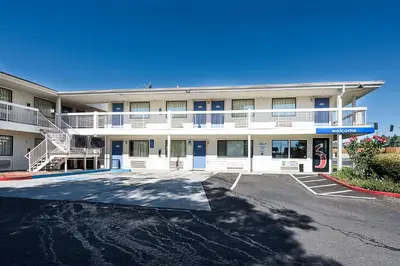 a large building with a parking lot in front of it at Motel 6-Sparks, NV - Airport - Sparks in Reno