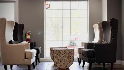a group of chairs in a room with a window at The Monarch Inn in Mariposa