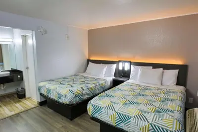 a hotel room with two beds and a sink at Motel 6-Sacramento, CA - Central in Sacramento