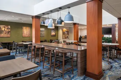 a dining area with tables and chairs in a restaurant at Fairfield Inn & Suites by Marriott Visalia Tulare in Tulare
