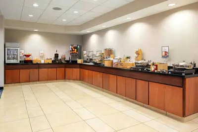 a lobby with a counter and a counter top at Fairfield Inn & Suites by Marriott Visalia Tulare in Tulare
