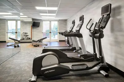 a gym with tread machines and a treadmill at Fairfield Inn & Suites by Marriott Visalia Tulare in Tulare
