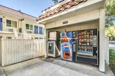 a building with a soda machine in front of it at Motel 6-Stockton, CA - North in Lincoln Village