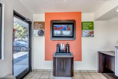 a corner of a restaurant with a tv on a wall at Motel 6-Stockton, CA - Charter Way West in Stockton