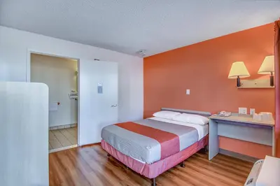 a hotel room with a bed and a desk at Motel 6-Stockton, CA - Charter Way West in Stockton