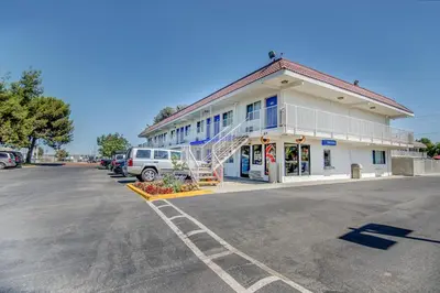 a parking lot in front of a building at Motel 6-Stockton, CA - Charter Way West in Stockton