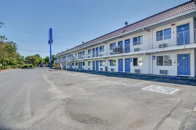 an empty parking lot in front of a building at Motel 6-Stockton, CA - Charter Way West in Stockton