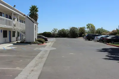 an empty parking lot in front of a building at Motel 6-Coalinga, CA - East in Coalinga