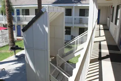a gate on the side of a building with a fence at Motel 6-Coalinga, CA - East in Coalinga
