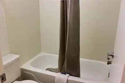 a bathroom with a tub and a toilet and a shower at Motel 6-Coalinga, CA - East in Coalinga